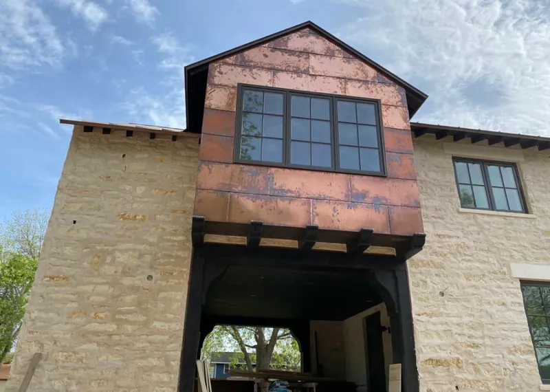 Copper metal panel facade on a stone building for Skylight Installation in PiÃ±on Hills