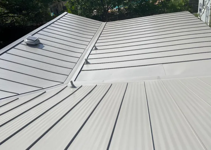Solar attic fan installed on a metal roof for Roof Ventilation in PiÃ±on Hills